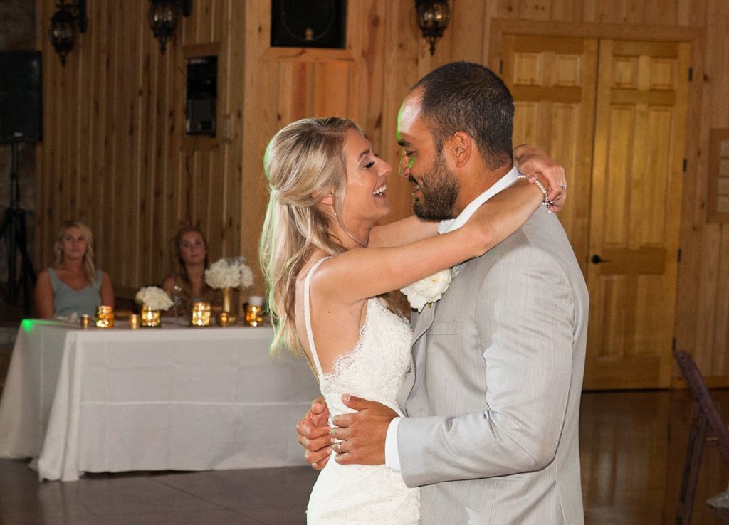 Bride and groom smiling during first dance