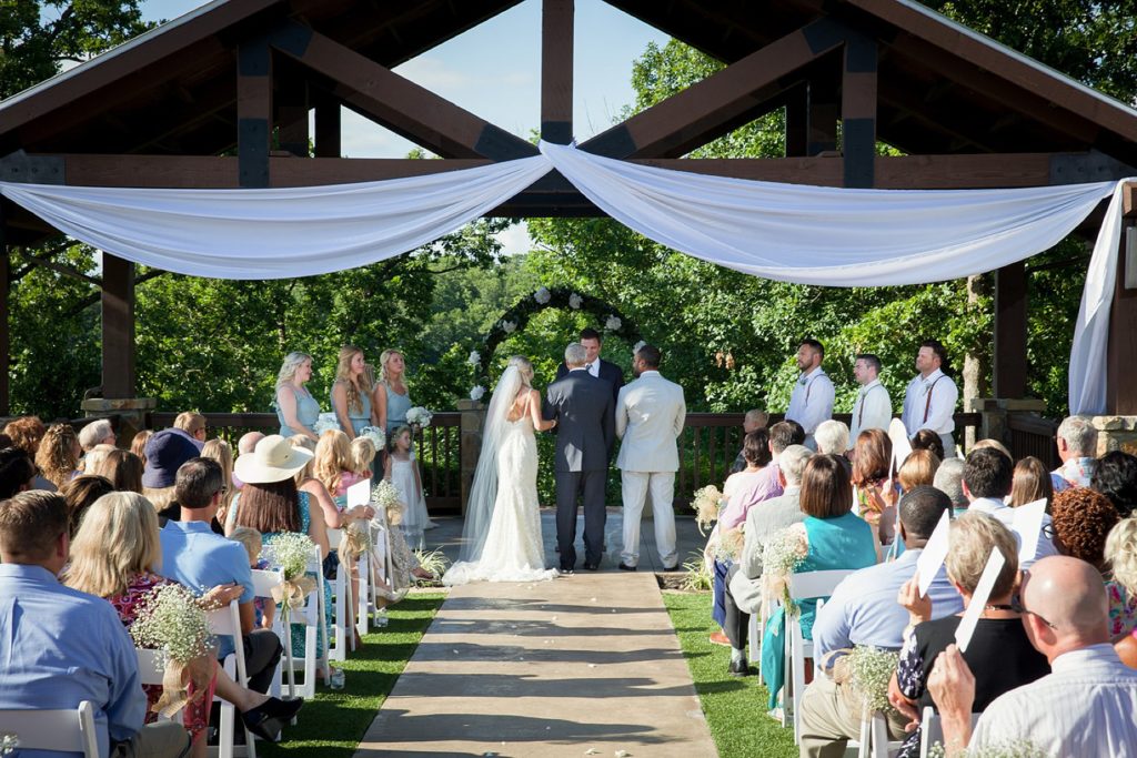 Bride, father of the bride and groom standing at outdoor alter at The Springs Wedding Event Center