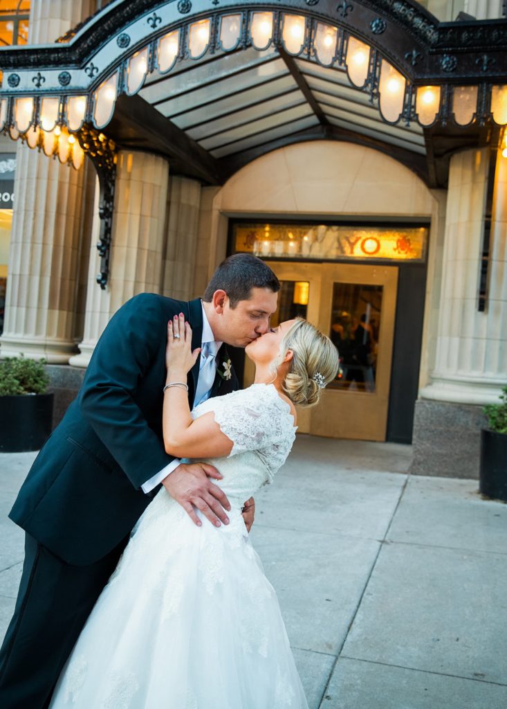 groom dips bride for kiss